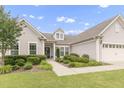 Attractive single-Gathering home with lush landscaping and a welcoming walkway to the front door at 118 Manning Way, Durham, NC 27703
