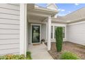 Inviting front entrance with a stylish door, decorative plants, and a covered porch area at 118 Manning Way, Durham, NC 27703