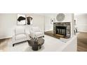Staged living room features stone fireplace, modern flooring and contemporary decor at 120 Jo Anne Cir, Cary, NC 27513