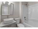 The bathroom has updated fixtures and a shower-tub combination with white cabinets at 1211 Freeman Dr, Sanford, NC 27330