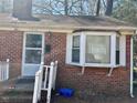 Charming single-story brick home featuring a cozy front porch and a bay window at 1310 Ray Ave, Sanford, NC 27330