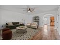Bright living room with neutral walls, modern furniture, a ceiling fan, and hardwood flooring at 1310 Silver Dr, Mebane, NC 27302