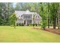 Attractive front yard with mature trees framing the two-story residence at 1508 Banks Brooke Dr, Raleigh, NC 27603