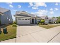 Lovely single-story home with a two-car garage, complemented by a lush lawn and landscaped garden at 1533 Santa Lucia St, Wake Forest, NC 27587