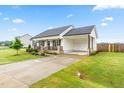 Well-maintained single-story home featuring a charming front porch and convenient attached carport at 173 Longbow Dr, Middlesex, NC 27557