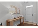 Welcoming foyer with a wooden console table, decorative mirrors, and hardwood floors at 2012 Sweet Samson St, Wake Forest, NC 27587