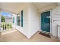 Inviting covered front porch featuring a teal door, complementing the home's charming exterior at 202 Homestead Park Dr, Apex, NC 27502
