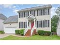 Charming two-story home featuring classic black shutters, a red front door, and a well-maintained lawn at 2301 Laurel Valley Way, Raleigh, NC 27604