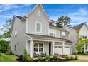 Charming two-story home with gray siding, manicured lawn and a two-car garage at 2426 Heron Watch Pl, Fuquay Varina, NC 27526