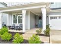 Inviting front porch with seating area and stylish house number display at 2426 Heron Watch Pl, Fuquay Varina, NC 27526