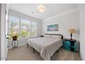 Bright bedroom with large windows, a queen-sized bed, and a tranquil ambiance at 247 Axis Deer Ln, Garner, NC 27529