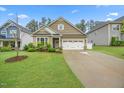 Charming home with manicured front lawn and two-car garage at 247 Axis Deer Ln, Garner, NC 27529