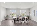 Bright dining room featuring wood floors, lots of light, and a modern dining table with seating for six at 260 Amber Acorn Ave, Raleigh, NC 27603
