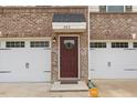 A welcoming front door flanked by a two-car garage, with clean lines and brick accents at 260 Amber Acorn Ave, Raleigh, NC 27603