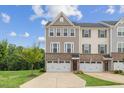 Charming townhome with a brick and siding facade, two-car garage, and a well-maintained front lawn at 260 Amber Acorn Ave, Raleigh, NC 27603