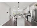 Modern kitchen featuring stainless steel appliances, a large island with barstool seating, and recessed lighting at 260 Amber Acorn Ave, Raleigh, NC 27603
