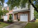 Attractive brick and siding townhome with a covered entryway and a well-kept front yard at 2950 Settle In Ln, Raleigh, NC 27614