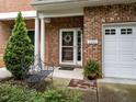 Inviting brick porch featuring decorative columns, a cozy bench, and a beautifully adorned front door at 2950 Settle In Ln, Raleigh, NC 27614