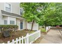 Attractive townhome exterior showcasing a well-maintained yard and inviting front entry at 300 Gilman Ln # 101, Raleigh, NC 27610