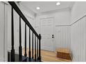 Welcoming foyer featuring a wood floor, wainscotting and black accents on the staircase at 3016 Bolo Trl, Raleigh, NC 27615