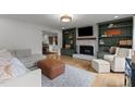Inviting living room with built-in bookcases, a fireplace, and comfortable seating at 3016 Bolo Trl, Raleigh, NC 27615