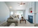 Cozy living room with fireplace, ceiling fan, and ample natural light at 3016 Hayling Dr, Raleigh, NC 27610