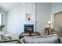 Living room with fireplace and decorative mantel, carpet, and furniture at 3016 Hayling Dr, Raleigh, NC 27610