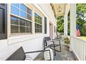 Inviting front porch with slate flooring, comfortable seating, and classic white railings at 307 Country Club Dr, Durham, NC 27712