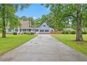 Inviting two-story home with a spacious driveway, well-kept lawn, and classic architectural details at 314 Lane Rd, Dunn, NC 28334