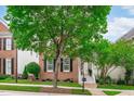 Inviting brick home with neat landscaping, black shutters, and a cozy front porch with steps at 321 Commons Walk Cir, Cary, NC 27519