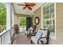 Charming front porch with comfortable chairs, ceiling fan, and stylish decor at 321 Commons Walk Cir, Cary, NC 27519