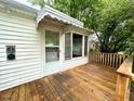 View of the wooden deck with white trim, perfect for outdoor relaxation and gatherings at 3810 Pendergrass St, Durham, NC 27704