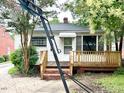 Cozy home featuring a wooden deck and basketball hoop, ideal for outdoor activities at 3810 Pendergrass St, Durham, NC 27704