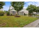 Two-story home showcasing well-maintained front yard with mature trees and a welcoming two-car garage at 4212 Auburn Hills Dr, Raleigh, NC 27616