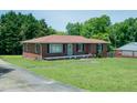Brick home with an inviting front porch and landscaping, perfect for curb appeal at 424 Camp Rd, Burlington, NC 27217
