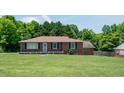 Traditional brick home with a well-manicured lawn, black shutters, and a cozy, inviting appeal at 424 Camp Rd, Burlington, NC 27217