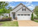 Beautiful single-Gathering home featuring a two-car garage, stone accents, and a well-manicured lawn at 47 Coventry Ln, Chapel Hill, NC 27516