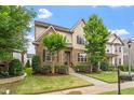 Beautiful home with a stone facade, lush lawn, and well-maintained landscaping at 5003 Blue Jack Oak Dr, Cary, NC 27519