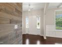 Elegant foyer featuring hardwood floors and an accent wall at 5011 Peachtree Town Ln, Knightdale, NC 27545