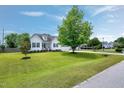 Welcoming home with well-kept lawn, mature trees, and a side-entry garage at 5016 Swordfish Dr, Raleigh, NC 27603