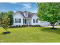 Beautiful home with a well-manicured lawn and mature trees creating an inviting curb appeal at 5016 Swordfish Dr, Raleigh, NC 27603
