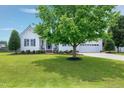Attractive home with a lush green lawn and mature tree at 5016 Swordfish Dr, Raleigh, NC 27603