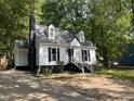 Well-maintained home with a long driveway and a traditional black and white color scheme at 503 Pine Run, Knightdale, NC 27545
