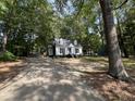 Inviting home nestled among lush trees, accessible via a long, paved driveway at 503 Pine Run, Knightdale, NC 27545