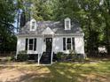 Beautiful home featuring a manicured lawn, dormer windows, and a classic chimney at 503 Pine Run, Knightdale, NC 27545