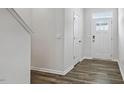 Bright entryway features a wood floor, white walls, and a front door with decorative window panels at 510 Resteasy Dr, Apex, NC 27539