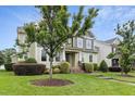 Two-story home with lawn, beautiful landscaping, stone steps and green siding providing an inviting exterior at 6444 Kit Creek Rd, Morrisville, NC 27560