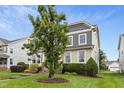 This two-story home boasts fresh landscaping, stone steps and green siding offering an inviting exterior at 6444 Kit Creek Rd, Morrisville, NC 27560