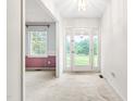 Bright entryway with white walls, carpeted flooring, and a glass front door allowing natural light at 6909 Hickory Dr, Raleigh, NC 27603