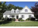 Inviting two-story home with a well-manicured lawn, charming front porch, and classic curb appeal at 70 Glen Oaks Drive Dr, Youngsville, NC 27596